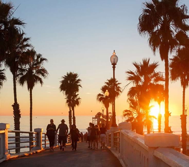 Pier People walking on a pier in the sunset