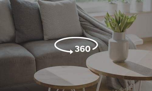 Picture of a living room couch and coffee table with a 360 icon to indicate there are virtual tours available